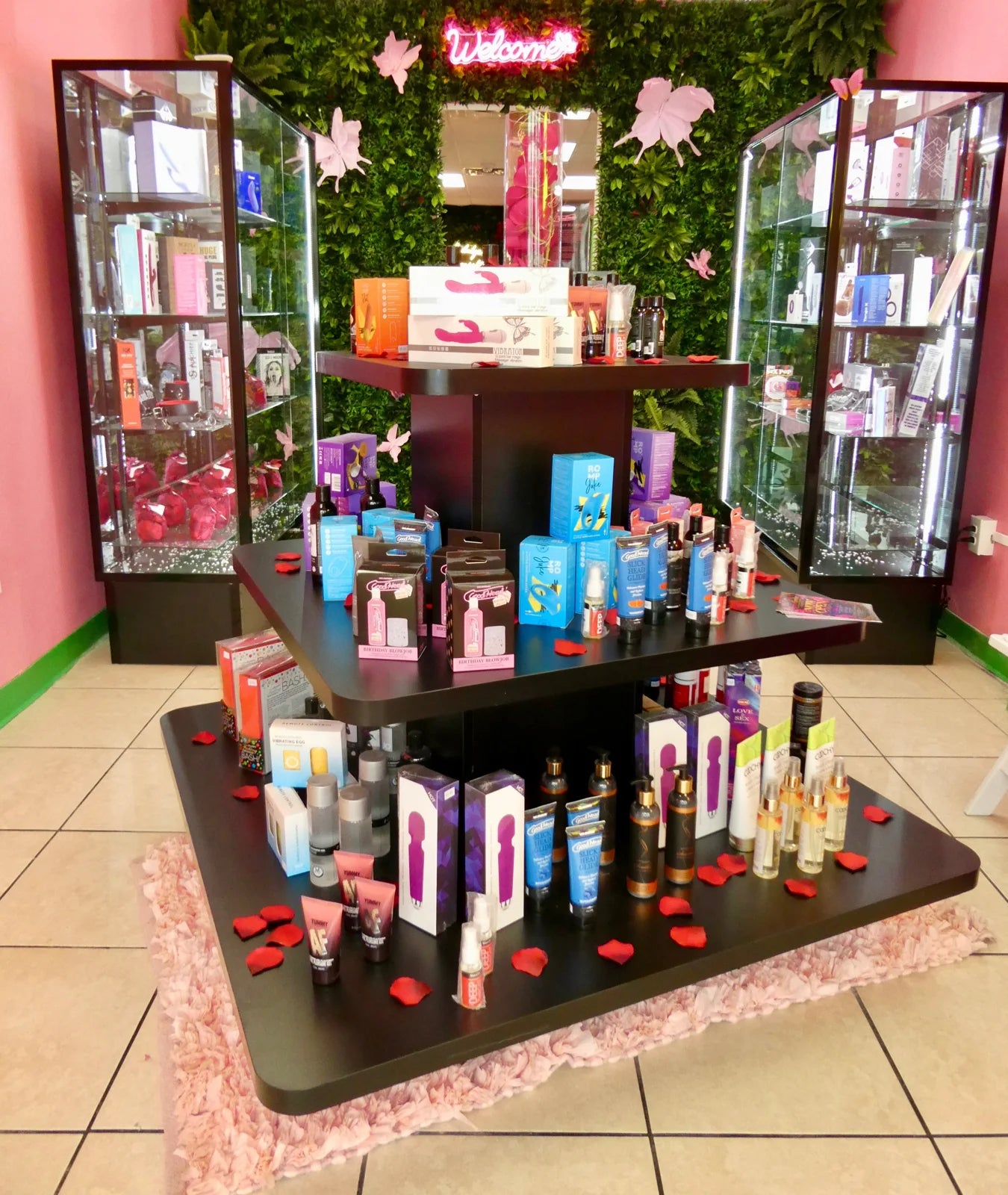 Inside Secret Garden: pink walls, green accents, and a central product display