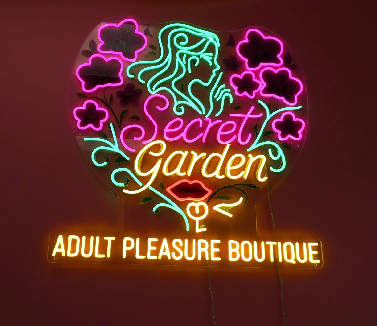 Pink, green, and gold Secret Garden neon sign